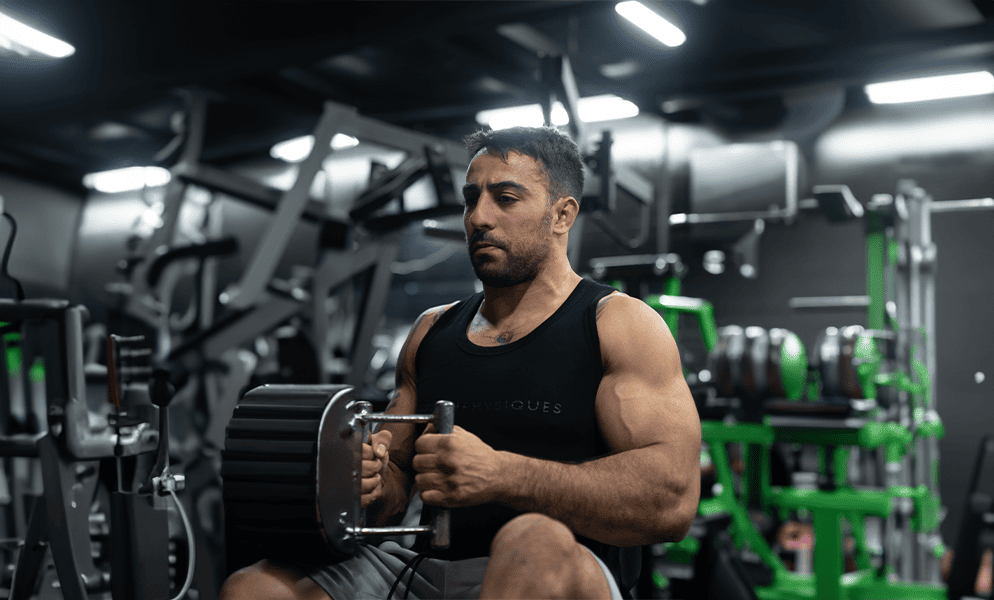 Raz Pilosof training with a dumbbell in the gym